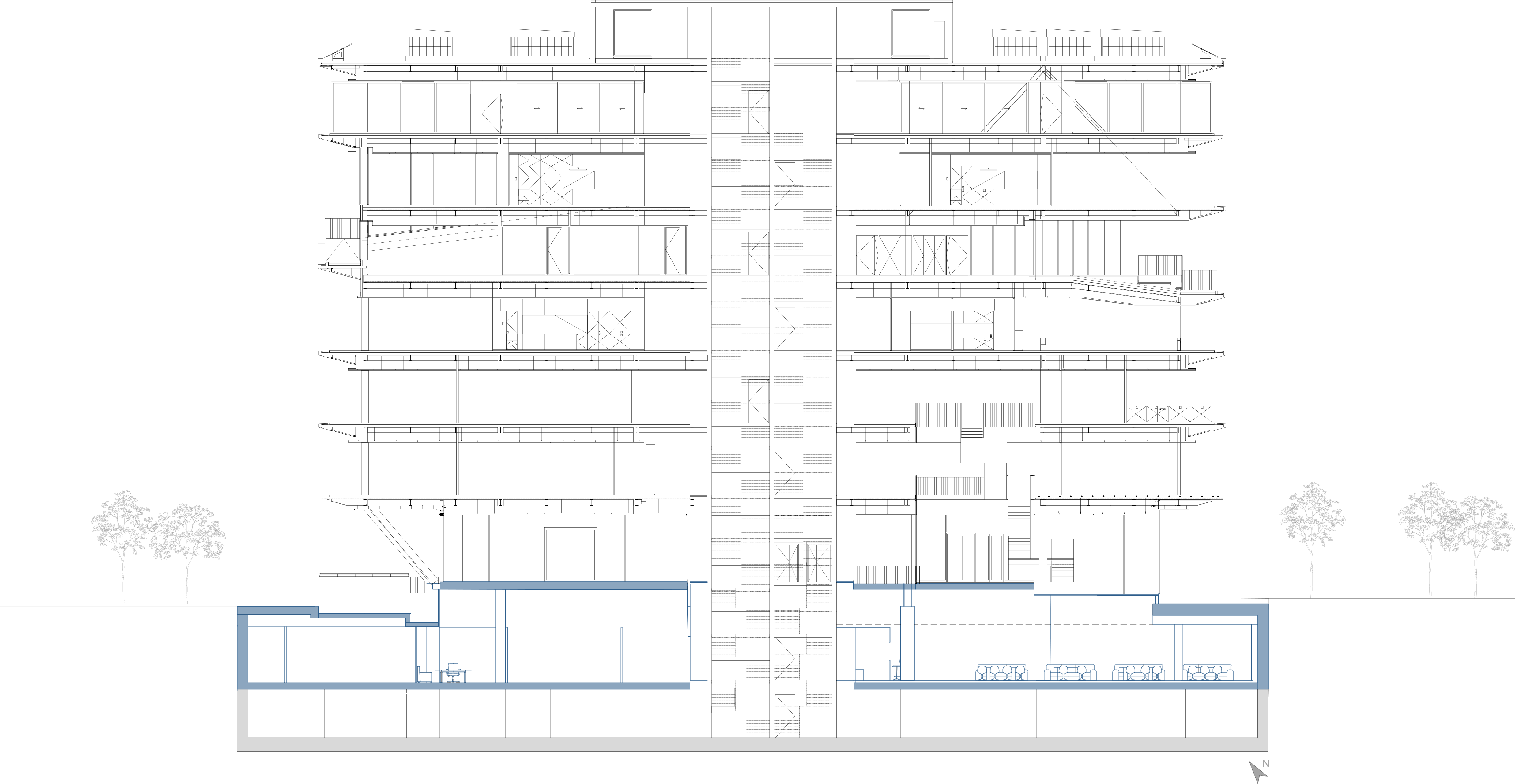 Section A–A′: the building above, the central circulation core, and the basement workspace with cafeteria seating.